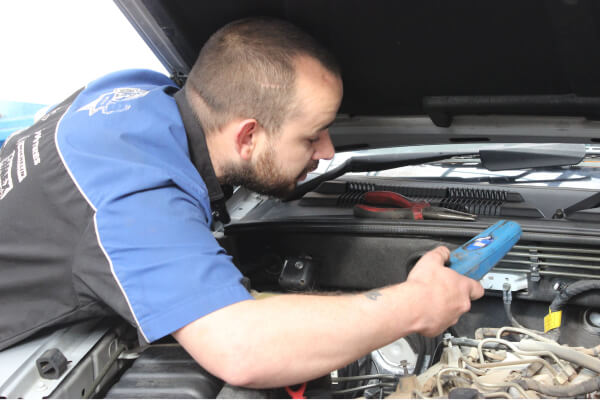 one of the boys inspecting a customers car on arrival